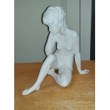 A continental parianware ceramic figure of a resting female nude, Kaiser, W. Germany