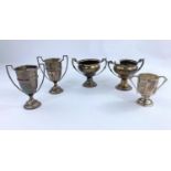 Five hall marked silver trophy cups of various dates and assay offices 10.7oz