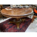 A Victorian mahogany tilt top circular supper table on pedestal base with lion's feet (no pins)