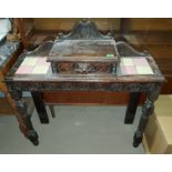 A carved oak side table with single drawer to the top, with inset tiles, on tapering front legs