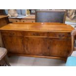 A reproduction yew wood sideboard