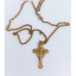 A 9ct gold crucifix pendant with Jesus in relief with etched crown of thorns to the reverse, on a