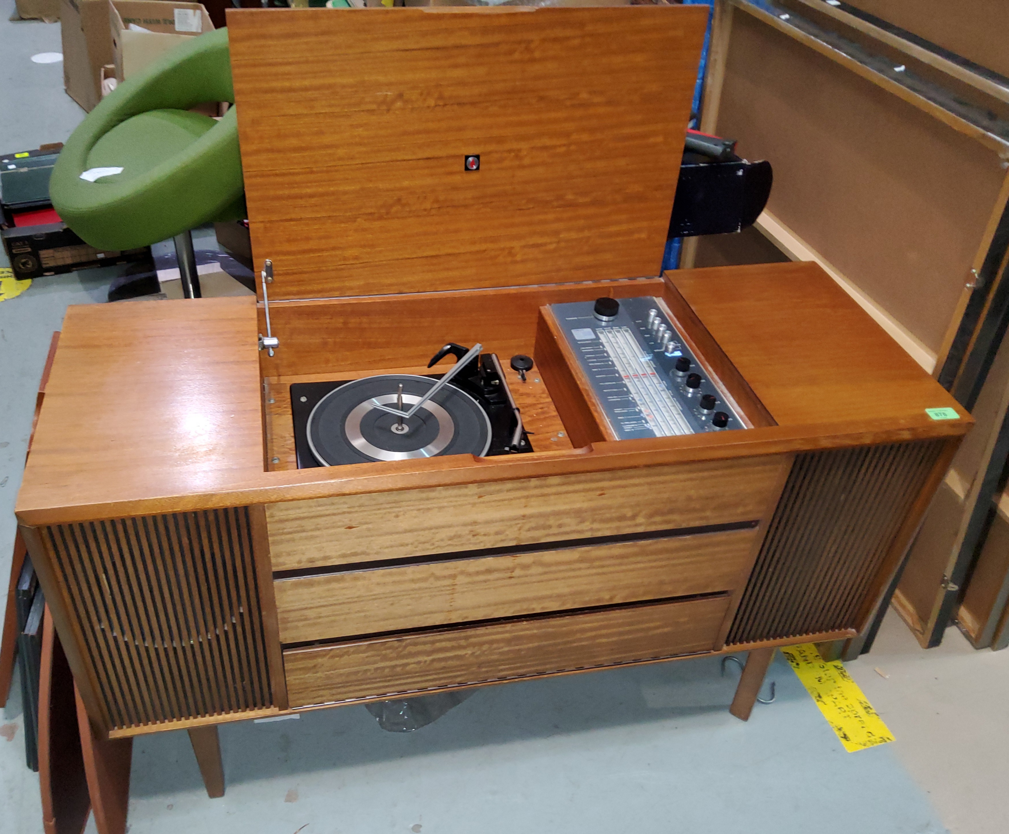 A Garrard record player in a mid century teak record player unit