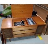 A Garrard record player in a mid century teak record player unit