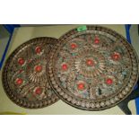 A Middle Eastern pair of unusual copper wall plaques with heavily embossed and 'jewelled'