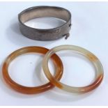 2 white/amber coloured hardstone bangles; a hallmarked silver bracelet.