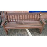 A brown painted wooden garden bench