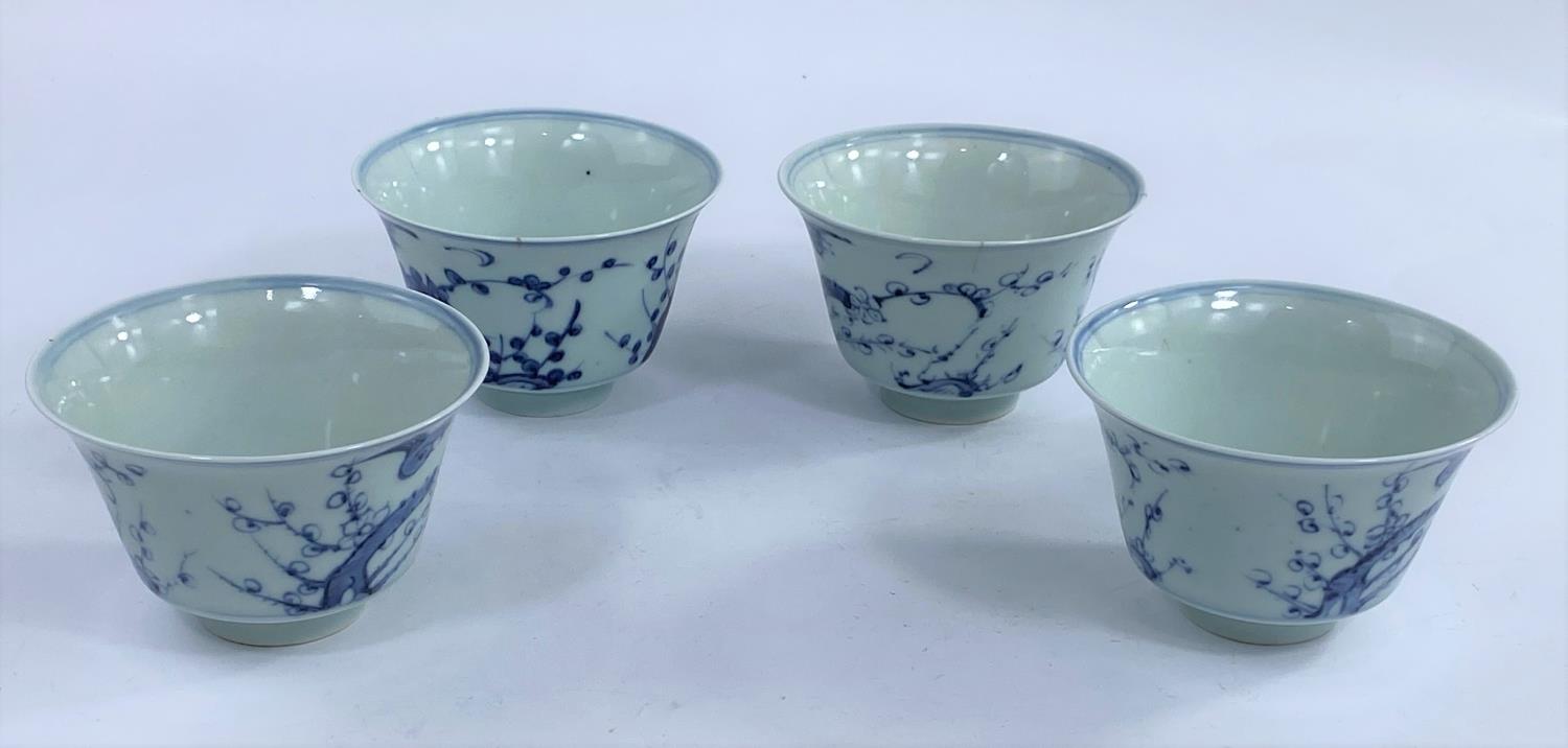 Four Chinese blue and white tea bowls with Prunus blossom decoration with birds, a character mark to