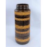 A 1960's tall cylindrical West German 'lava ware' vase in brown and yellow with ringed decoration