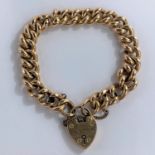 A large link curb chain bracelet, stamped '15c', with heart lock, stamped '15c', 19.9 gm