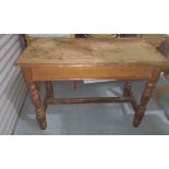 A pitch pine kitchen side table, rectangular top with canted edges, turned legs and H-stretcher