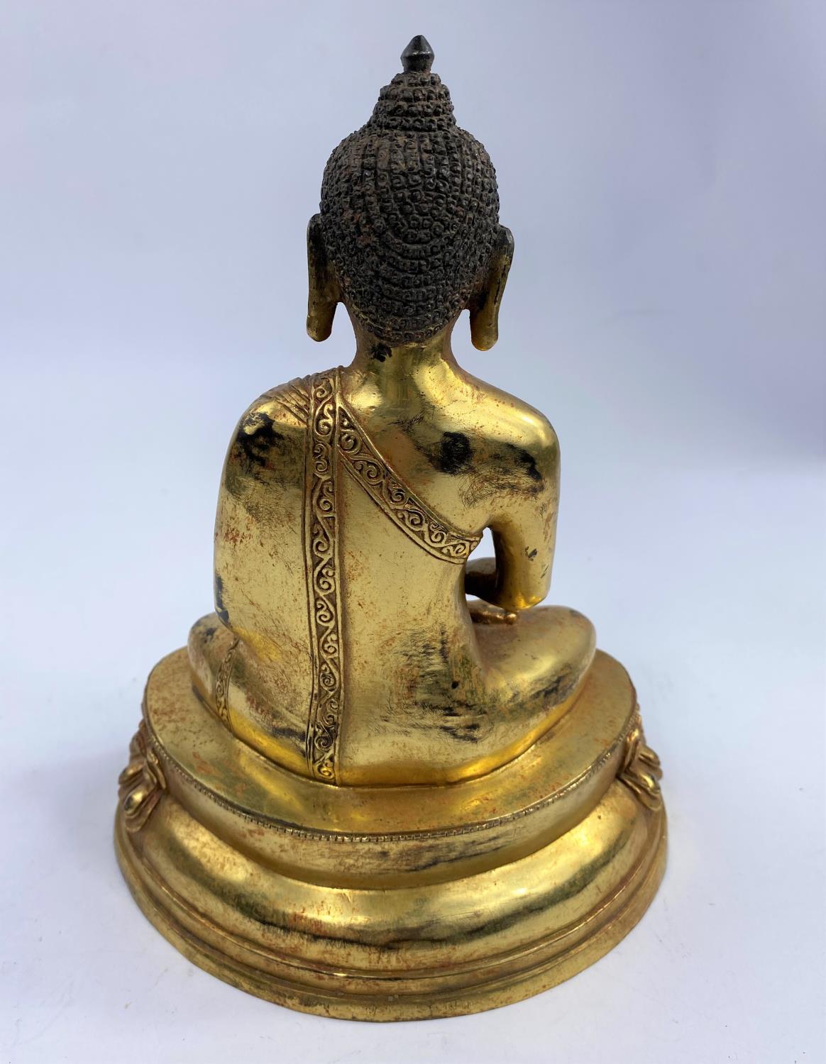 A Chinese bronze gilded figure of a buddha in lotus position, ht 23cm - Image 2 of 3