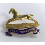 A yellow metal and enamel military badge "West Yorkshire", stamped '9ct', 4.9 gm