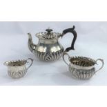 A hallmarked silver bachelor's 3 piece tea set of oval form with gadrooned lower section, Chester