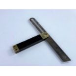 A 19th century adjustable angle forming steel sliding bevel with ebony and brass stock.