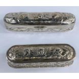 Two hall marked silver trinket boxes, both with embossed cherub decoration one slightly longer 17cm,