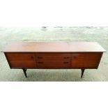 A mid 20th century teak dining suite by Younger comprising a long low sideboard with two doors etc