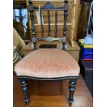 A late Victorian ebonised spindle back child's chair with incised gilt decoration, turned tapering