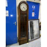 A 1930's oak arch top long case clock with weight driven striking movement
