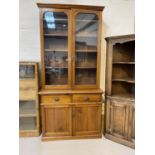 A Victorian walnut full height bookcase with 2 glazed doors over 2 drawers and double cupboard,