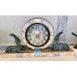 An Art Deco style marble mantle clock with circular central clock with two spelter antelope to