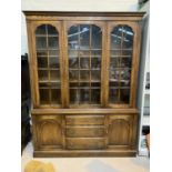 An oak "Reprodux" library bookcase with three astragal glazed doors above, three central drawers