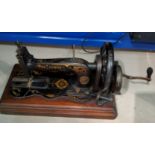 A vintage Singer hand operated sewing machine in mahogany case