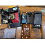 An early KODAK Brownie folding camera and 5 others.