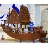 A Chinese hardwood model of a 2 masted junk with slatted sails and carved dragon prow, length 61cm