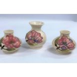 A Moorcroft Magnolia cream ground vase with bulbous body and flared rim, height 9cm, a matching pair