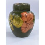 A Moorcroft Hibiscus pattern ginger jar with green ground, monogrammed to base, height 15.5cm