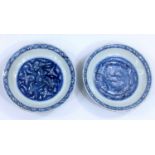A pair of 18th / 19th century Chinese dishes with blue and white decoration of 3 circling central