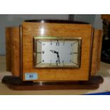 A mantel clock, the Art Deco case in dark wood with bird's eye maple veneer