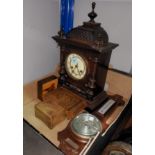 An Edwardian mantel clock with striking movement in stained wood architectural case; an aneroid