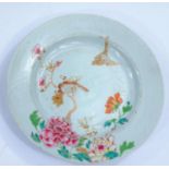 A 19th century Chinese famille rose dish decorated with flowers, a bird on branch and one in flight,
