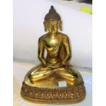 A Chinese bronze gilded figure of a buddha in lotus position, ht 23cm