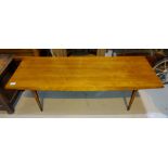 A mid 20th century walnut coffee table by Gordon Russell of slightly swelling rectangular form,