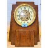 An Art Deco style mahogany cased clock in an architectural design with circular dial, height 31cm (