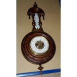 A walnut cased aneroid wall hanging barometer