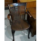 An early 20th century office chair with rib back and solid seat; a modern swivel armchair in black