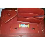 An early / mid 20th century red leather desk set including blotter, letter rack, pen stand,