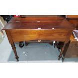 A Victorian pitch pine side table/desk with half opening top, on decorative turned legs, bears label