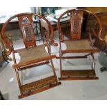 A pair of Chinese hardwood 'Huanghuali' folding horseshoe back armchairs with pierced splats,