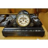 A Victorian mantel clock in black and variegated marble drum shaped case, with French striking