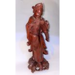 A Chinese carved wooden figure of a sage with bead eyes to face and shoulder, height 30cm