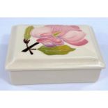 A Moorcroft Magnolia cream ground lidded rectangular trinket box and a Moorcroft Hibiscus green