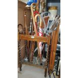 A 1920's 2 division stick stand with barley twist supports containing a selection of walking