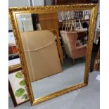 A large rectangular wall mirror with bevelled edge