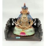 A Chinese ceramic Buddah with polychrome decoration, seated in lotus postition height 30cm, with