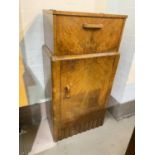 An Art Deco walnut drinks cabinet with fall front mirrored interior and cupboard bellow, height